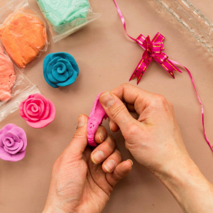 A woman paints clay products. Hobby clay modeling